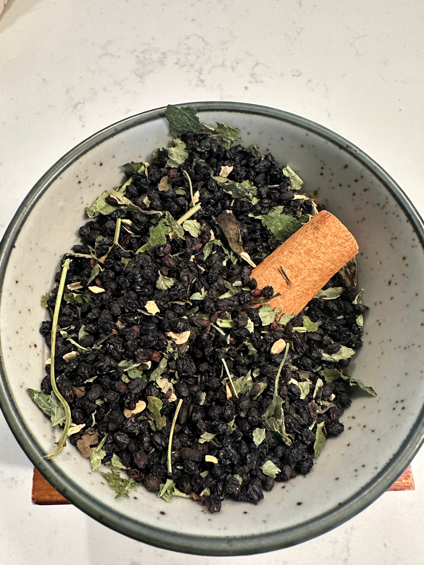 Lemon Balm + Mint botanical tea blend in a ceramic bowl